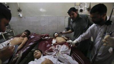 Family members and hospital staff tend to injured students after they were brought to the Lady Reading Hospital in Peshawar after gunmen opened fire on a school bus. Fayaz Aziz / Reuters