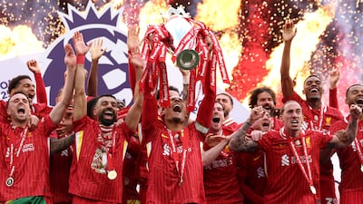 Liverpool's Virgil van Dijk lifts the Premier League trophy after the final game of the season against Crystal Palace at Anfield on Sunday, May 25, 2025. Getty Images