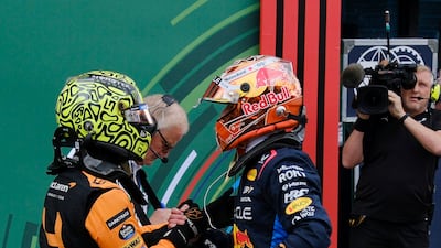 McLaren's Lando Norris celebrates after qualifying in pole position with second-placed Red Bull's Max Verstappen. Reuters
