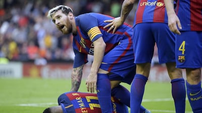 Barcelona forward Neymar, left, lies on the pitch after Valencia fans threw objects after teammate Lionel Messi scored the winning goal in a 3-2 victory over Valencia at the Mestalla on Saturday, October 22, 2016. Manu Fernandez / AP Photo