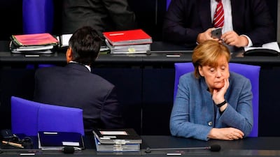 German chancellor Angela Merkel and vice chancellor and foreign minister Sigmar Gabriel take their seats to attend a plenary session at the Bundestag in Berlin. John Mac Dougall / AFP Photo