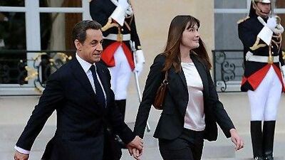 France's formerd president Nicolas Sarkozy and his wife, Carla Bruni-Sarkozy, leave the Elysee presidential palace after the formal investiture ceremony between France's president-elect Francois Hollande and his predecessor Mr Sarkozy, on May 15 in Paris.