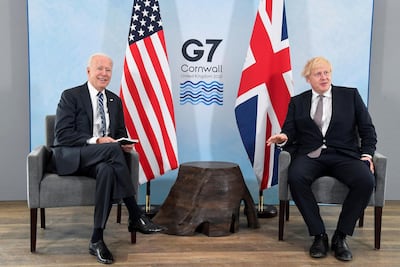 US President Joe Biden, left, poses for a photo with Britain's Prime Minister Boris Johnson, during their meeting ahead of the G7 summit in Cornwall, Britain, Thursday June 10, 2021. AP