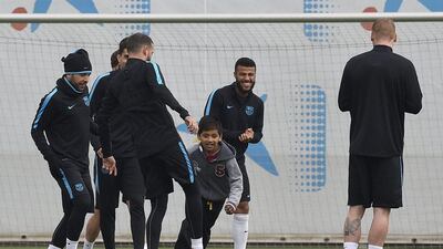 Barcelona’s team members play with children who gate-crashed the training session at the Sports Center FC Barcelona Joan Gamper in Sant Joan Despi, near Barcelona on March 14, 2016, on the eve of the Uefa Champions League last sixteen second leg football match between FC Barcelona and Arsenal. AFP / LLUIS GENE