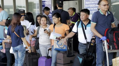 Overseas Filipino workers (prepare to board a flight in Manila. (Romeo Ranoco / Reuters)