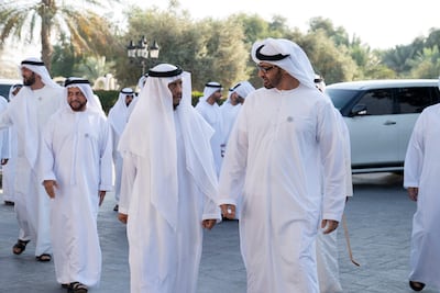 Sheikh Mohamed bin Zayed, Crown Prince of Abu Dhabi and Deputy Supreme Commander of the UAE Armed Forces, speaks with Sheikh Sultan bin Zayed, UAE President's Representative, during a Sea Palace barza in 2018. Eissa Al Falahi is on the far left. Mohamed Al Hammadi / Ministry of Presidential Affairs