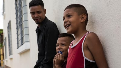 Migrants from Honduras wait outside the Migrant's House shelter in Guatemala City, Friday, July 26, 2019. AP