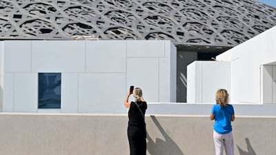 Visitors outside the Louvre Abu Dhabi. Moody's says geopolitical risks are partly mitigated by Abu Dhabi's very large government financial assets that support the government's capacity to absorb shocks. Khushnum Bhandari / The National