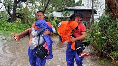 Coastguard personnel evacuate people in Santa Ana, Cagayan province. EPA