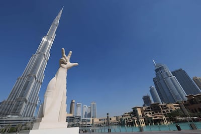 An artwork called in front of Burj Khalifa. The three finger hand gesture, coined by Sheikh Mohammed bin Rashid, means Win, Victory and Love. AFP