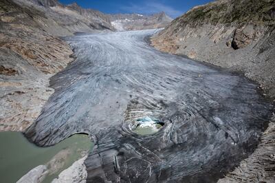 An aerial photograph taken above Gletsch, in the Swiss Alps shows a hole in the part of the Rhone Glacier revealing its glacial lake due to the melting of the glacier. Climate change was one of the central issues in the elections. AFP