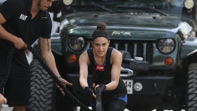 Dana Shamlawi pulls a 4x4 car during the final day of the UAE Strongman Competition in Dubai. Delores Johnson / The National