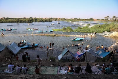 People cool off on the banks of the Nile during high temperatures in Egypt. Bloomberg
