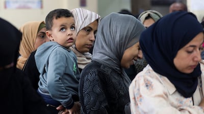 Palestinians queue to register for medical examinations at a health centre run by UNRWA in Deir Al Balah in the central Gaza Strip on October 29, 2024. Reuters