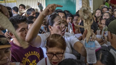 Filipinos crowd a polling station in Manila. Getty Images