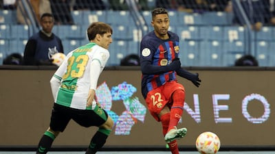 Barca forward Raphinha is challenged by Juan Miranda. AFP