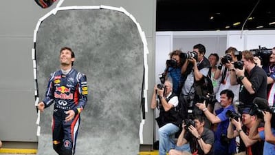 The flip side of Formula One racing for the drivers is the waiting between races. With the season finally about to start Sunday with the Australian Grand Prix, Red Bull's Mark Webber is having fun with it as photographers snap away.