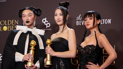 From left: Audrey Nuna, Ejae and Rei Ami pose with the Best Original Song - Motion Picture award for Golden from KPop Demon Hunters. Reuters