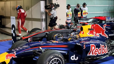 The 2010 Abu Dhabi Grand Prix will always be remembered as the race where Ferrari's Fernando Alonso missed the chance to become world champion. Here you see the dejected Alonso walking into the garage as Sebastian Vettel, the new world champion arrives to claim the prize.