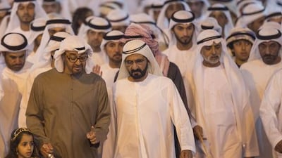 Sheikh Mohammed bin Rashid, Vice President and Ruler of Dubai, and Sheikh Mohammed bin Zayed, Crown Prince of Abu Dhabi, at the parade with Sheikha Fatima bint Mohammed, left, and Sheikh Nahyan bin Mubarak, Minister of Culture Youth and Community Development. Ryan Carter / Crown Prince Court - Abu Dhabi