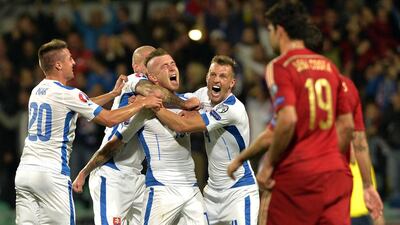Juraj Kucka, centre, is ecstatic with teammates after he scored during the team’s win over European champions Spain. Samuel Kubani / AFP