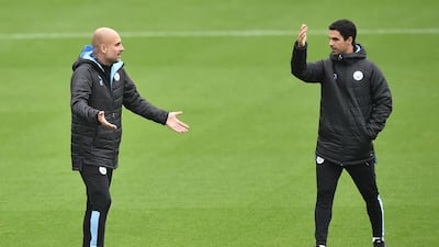 Pep Guardiola, left, talks to Mikel Arteta. Getty