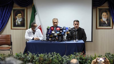 Iran's Foreign Minister, centre, and Azerbaijan's ambassador to Tehran Ali Alizada, right, at a press conference at the Tajrish hospital in Tehran. AFP