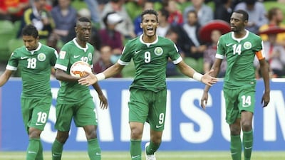 Saudi Arabia's Naif Hazazi, second right, celebrates his goal with teammates Salem Al Dawsari, left, Hassan Muath Fallatah, second left and Saud Kariri, right, during their win over North Korea at the Asian Cup in Melbourne, Australia on Wednesday. Brandon Malone / Reuters / January 14, 2015