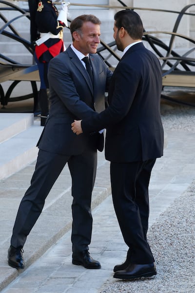 French President Emmanuel Macron, left, shakes hands with Iraqi Prime Minister Ali Al Zaidi at the Elysee Palace in Paris. Reuters
