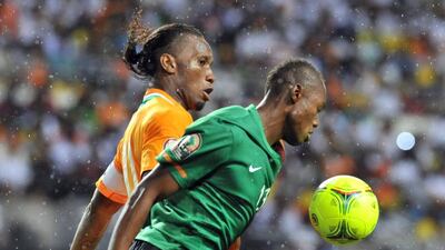 Stoppila Sunzu, right, defends Didier Drogba during a 2012 Africa Cup of Nations match. Issouf Sanogo / AFP