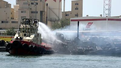 Fire crews tackled a blaze which ripped through a ship in Sharjah carrying thousands of gallons of diesel and more than 100 vehicles. Chris Whiteoak / The National