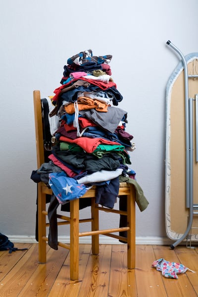 It’s useful to think of the clothes chair as a staging area or a visual to-do list as opposed to a fabric mountain of shame. Getty Images