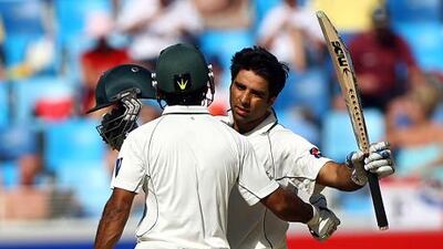 Pakistan's Taufiq Umar raises his bat after scoring a half-century.