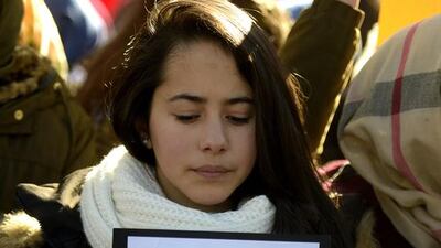 A Muslim woman holds a poster in Madrid on January 11, 2015 during a show of solidarity following three days of bloodshed triggered by an attack on French satirical weekly Charlie Hebdo that left 12 dead. From London to Berlin via Washington and Montreal, rallies are organised throughout the weekend with the highlight in Paris where more than a million people and dozens of world leaders are expected to participate in a massive and historic march in Paris today in solidarity with the victims of the Islamist attacks that killed 17 and deeply shook the country. Gerard Julien / AFP photo