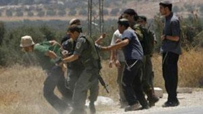 Israeli border police officers detain a Jewish settler after he disrupts Palestinian traffic at the Hawara checkpoint near Nablus.