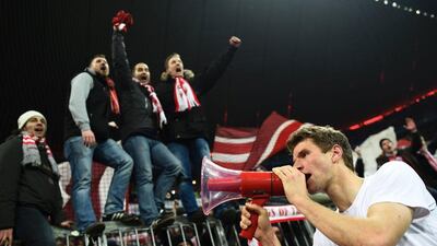 Bayern Munich’s midfielder Thomas Muller celebrates win fans after the Uefa Champions League, Round of 16, second leg football match FC Bayern Munich v Juventus in Munich, southern Germany on March 16, 2016. AFP / ODD ANDERSEN