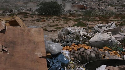 Municipality trucks drop solid waste in a dumping ground in Umm Al Quwain, where the days of traditional landfill are numbered. Amy Leang / The National