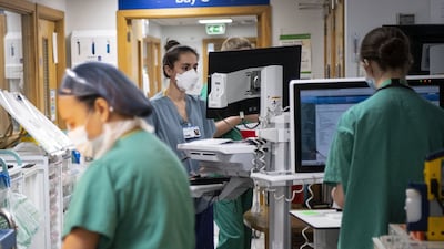File photo dated 07/01/21 of Staff nurses working in the corridor in the Acute Dependency Unit at St George's Hospital in Tooting, south-west London. The number of people having to wait more than 52 weeks to start hospital treatment in England was 299,478 in February, down from 311,528 the previous month.Issue date: Thursday April 14, 2022.