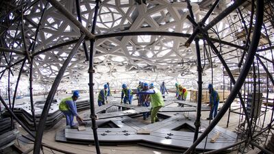 Men work on the ceiling for Louvre Abu Dhabi in May 2015. Christopher Pike / The National