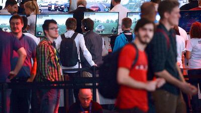 Above, visitors at the display of car and driving game The Crew, which will launch on PC, PlayStation 4, Xbox 360, and Xbox One on November 11 in the United States. Henning Kaiser / AFP