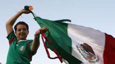 Pablo Mangino, a pilot with Etihad Airways, wears his Mexican football team uniform and waves his country's flag.