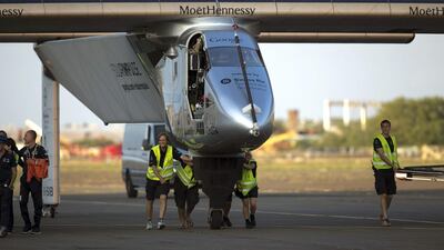 Ground crew push the Solar Impulse 2 plane towards the hangar after landing at the Kalaeloa Airport in Kapolei, Hawaii. Marco Garcia / AP Photo