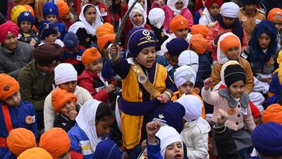 Sikh children wait for the result in a turban-tying competition in Amritsar. AFP