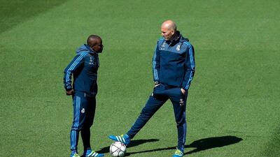 Zinedine Zidane, Manager of Real Madrid (r) talks with Hamidou Msaidie, Assistant Coach of Real Madrid during a training session ahead of the Uefa Champions League semi-final second leg between Real Madrid and Manchester City at Valdebebas training ground on May 3, 2016 in Madrid, Spain. (Photo by Gonzalo Arroyo Moreno/Getty Images)