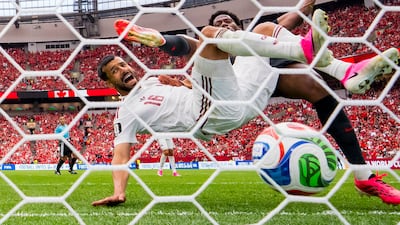 Canada forward Jonathan David (R) outbattles Qatar defender Boualem Khoukhi (C) to score his second goal during the first half of the FIFA World Cup 2026 group stage match between Canada and Qatar in Vancouver, Canada. EPA