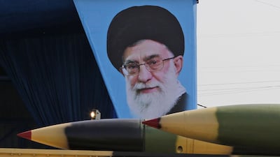 An Iranian military lorry carries surface-to-air missiles past a portrait of Iran's Supreme Leader Ayatollah Ali Khamenei during a parade. AFP