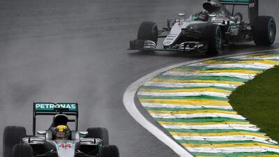 Lewis Hamilton, left, leads the Brazilian Grand Prix ahead of title rival and Mercedes teammate Nico Rosberg at the Interlagos circuit in Sao Paulo on Sunday. Vanderlei Almeida / AFP
