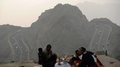 Men rest atop Al-Hada Mountain in Taif City, Saudi Arabia. Mohamed Al Hwaity / Reuters