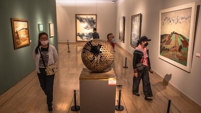 Museum goers wearing protective face masks visit 'A tribute to donors' exhibition at the National Art Museum of China on the first day after reopening. EPA/ROMAN PILIPEY