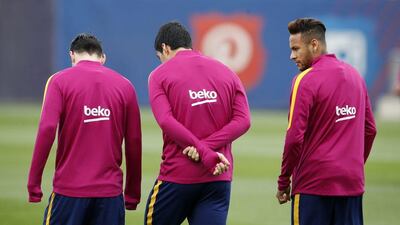 Barcelona’s Lionel Messi (L), Luis Suarez (C) and Neymar attend a training session prior to “Clasico” match against Real Madrid. REUTERS/Albert Gea